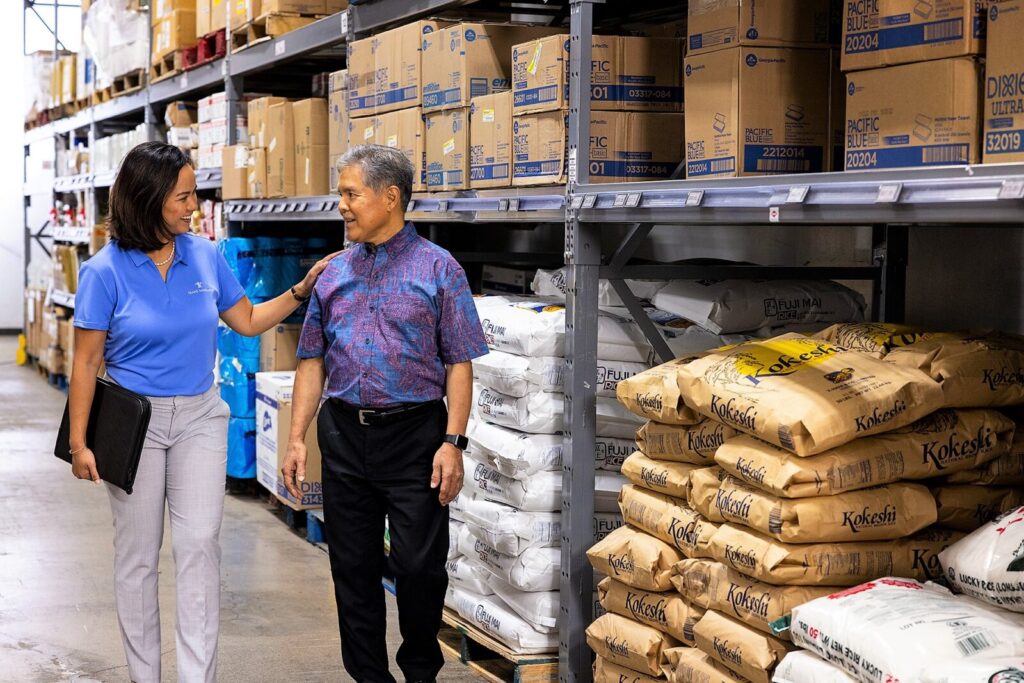Island agent helping business customer in warehouse