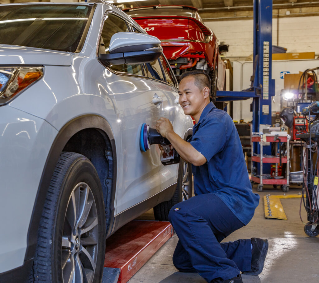 certified auto repair shop technician working on a car